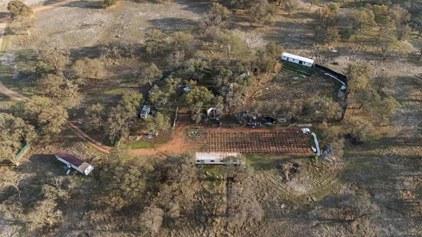 an aerial view of residential houses with outdoor space and mountain view