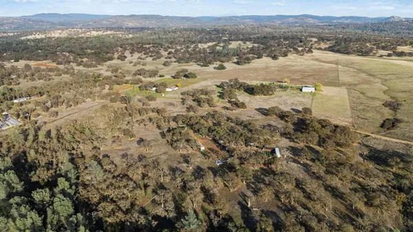 a view of a field with mountains in the background