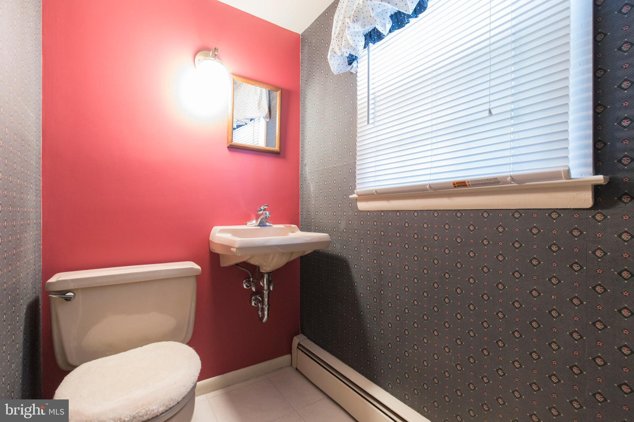 244 Shawnee Road Ardmore, PA 19003 - Photo 15 of 30 a bathroom with a sink a toilet and a mirror