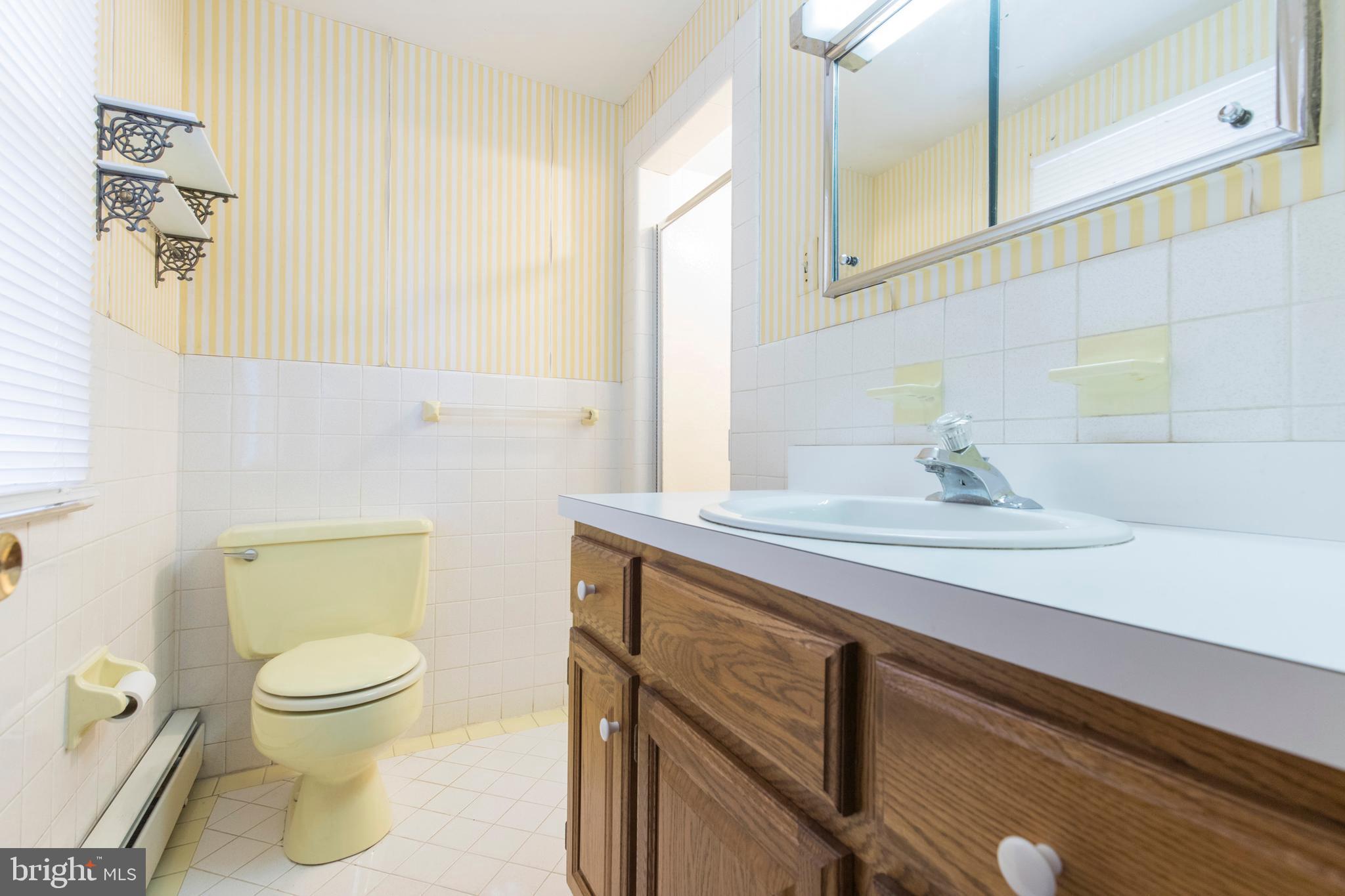 244 Shawnee Road Ardmore, PA 19003 - Photo 21 of 30 a bathroom with a sink a toilet and mirror