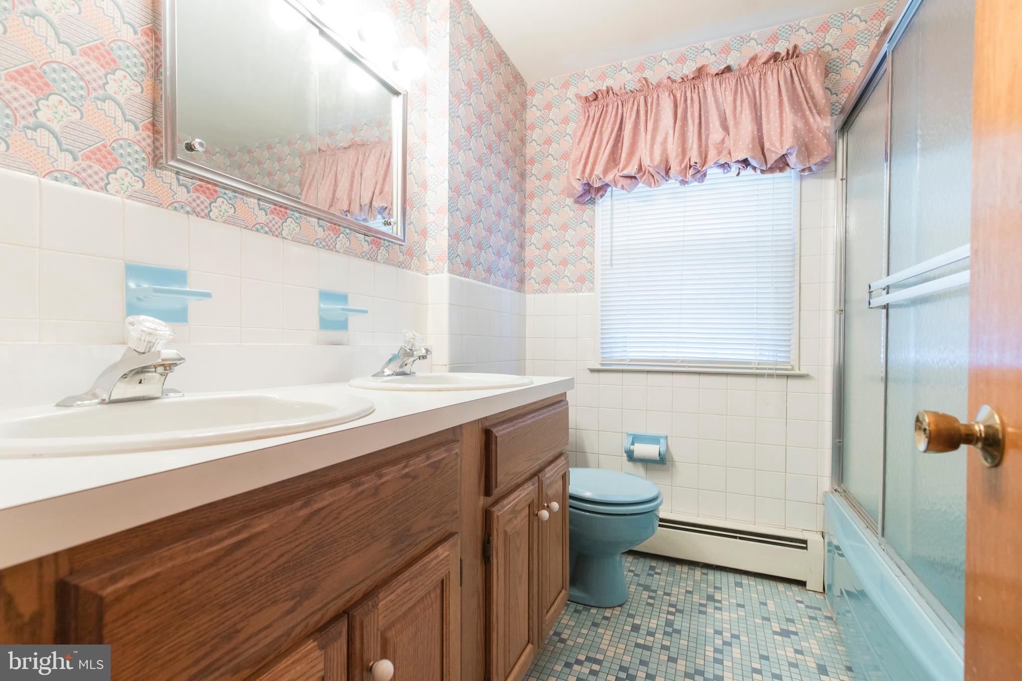 244 Shawnee Road Ardmore, PA 19003 - Photo 29 of 30 a bathroom with a sink a toilet and shower curtain