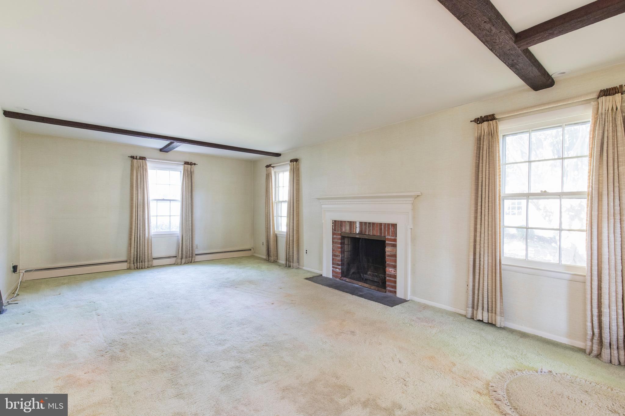 244 Shawnee Road Ardmore, PA 19003 - Photo 8 of 30 an empty room with windows and fireplace