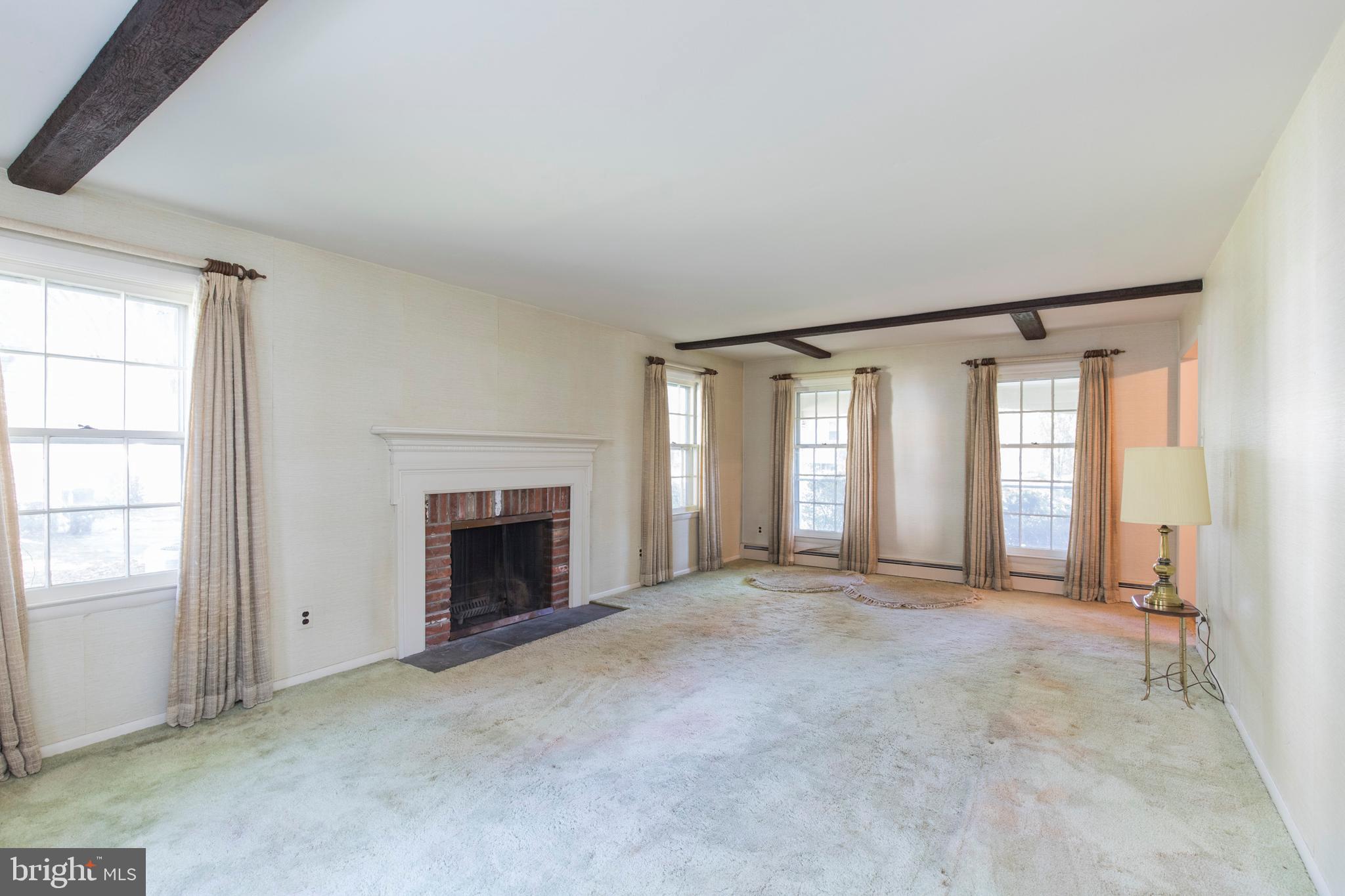 244 Shawnee Road Ardmore, PA 19003 - Photo 9 of 30 an empty room with windows and fireplace