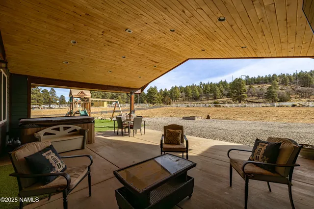 a view of a chairs and table in patio with a lake view