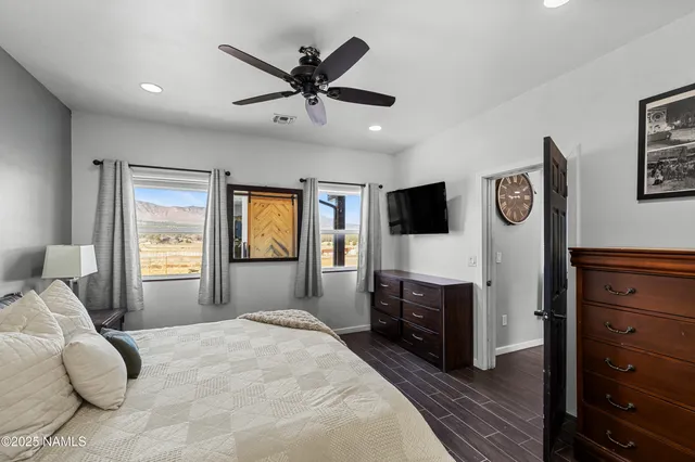 a bedroom with a bed and a flat screen tv