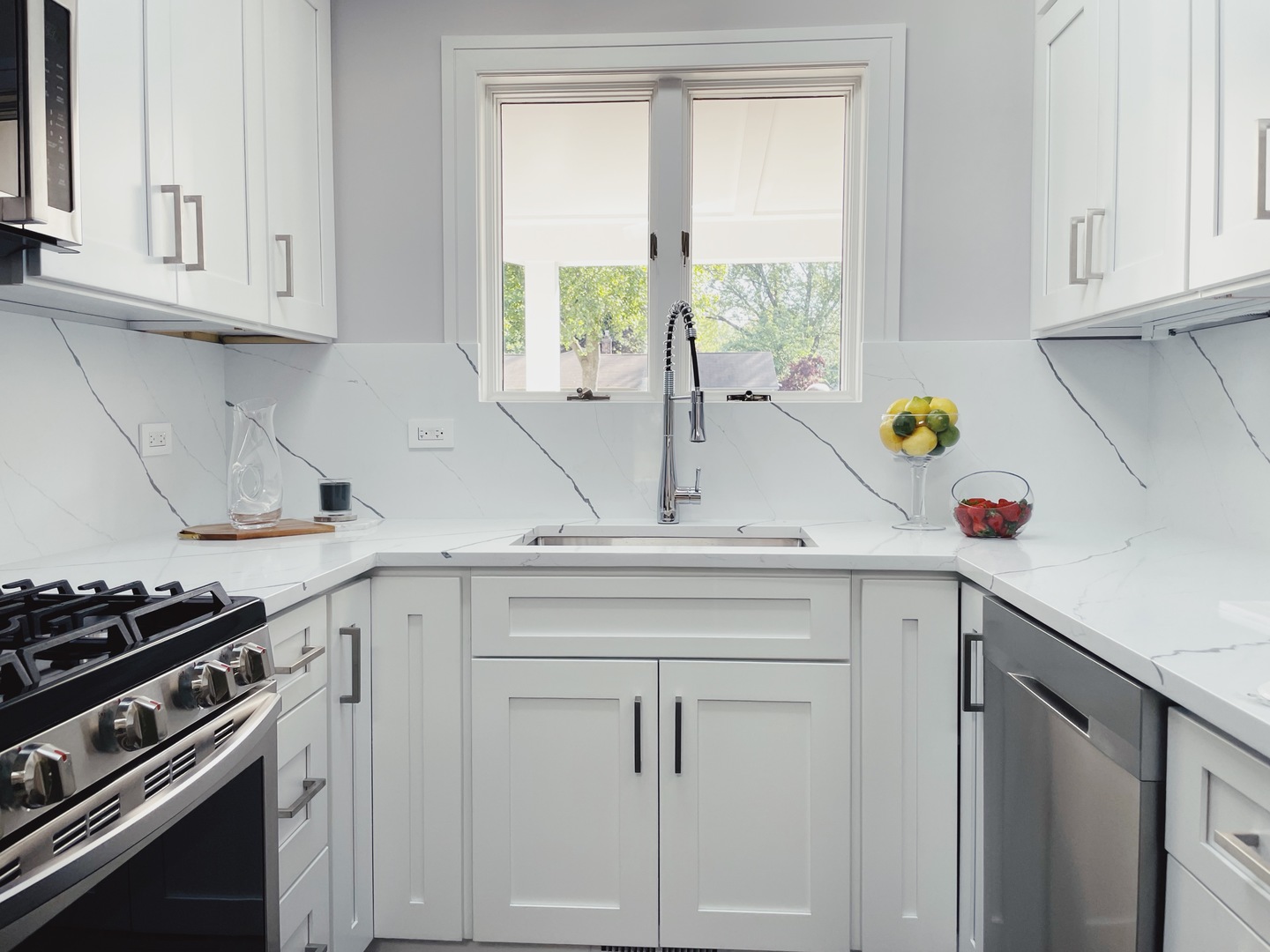 1017 Dell Road Northbrook, IL 60062 - Photo 15 of 52 a kitchen with white cabinets and a window