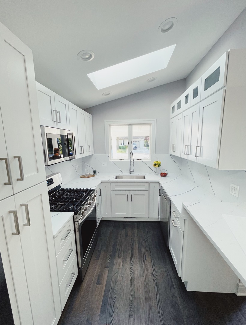 1017 Dell Road Northbrook, IL 60062 - Photo 18 of 52 a kitchen with granite countertop white cabinets a sink dishwasher and a stove with wooden floor