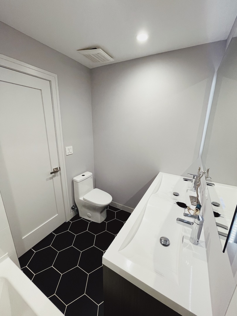 1017 Dell Road Northbrook, IL 60062 - Photo 29 of 52 a bathroom with a sink a toilet and a mirror