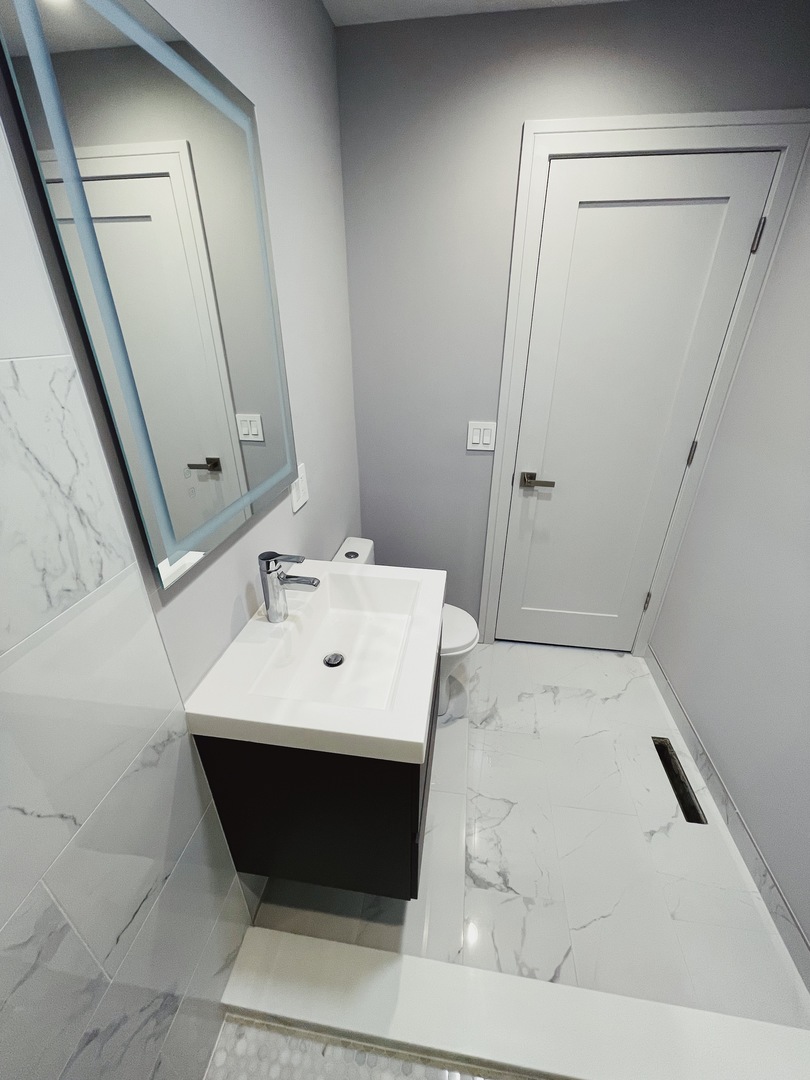 1017 Dell Road Northbrook, IL 60062 - Photo 35 of 52 a bathroom with a sink a toilet and a mirror