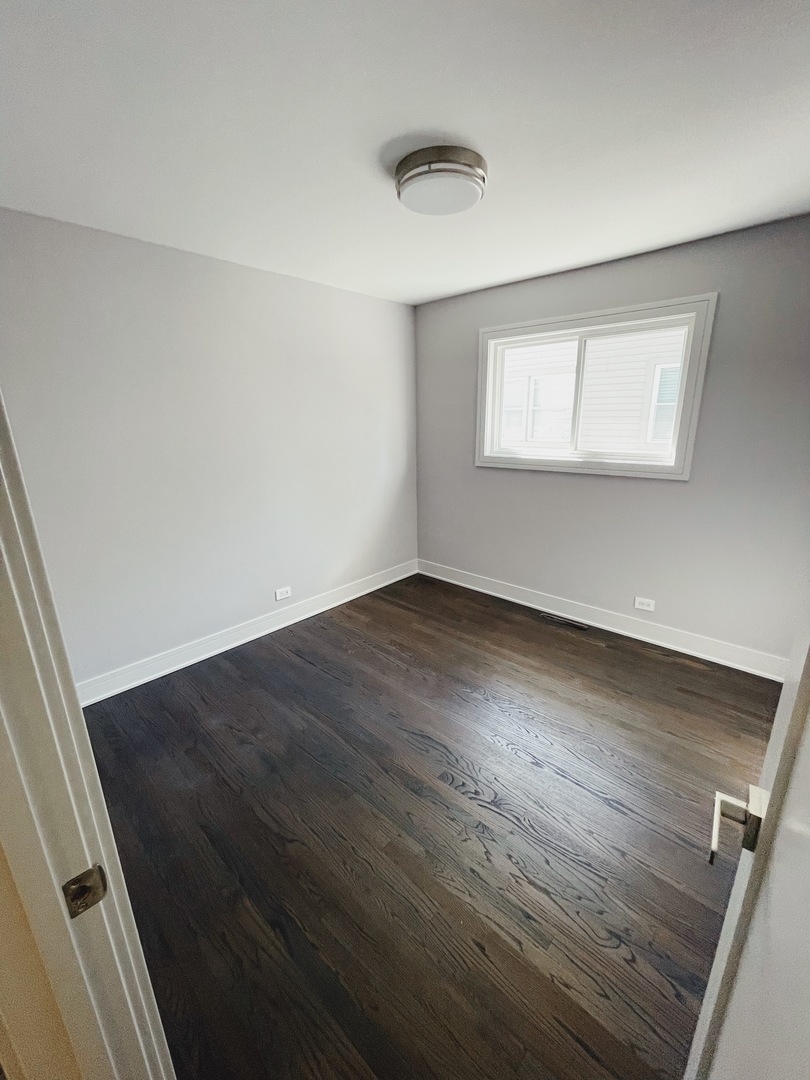 1017 Dell Road Northbrook, IL 60062 - Photo 38 of 52 an empty room with wooden floor and windows