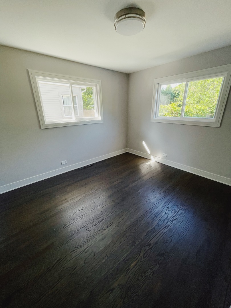 1017 Dell Road Northbrook, IL 60062 - Photo 39 of 52 a view of an empty room with wooden floor and a window