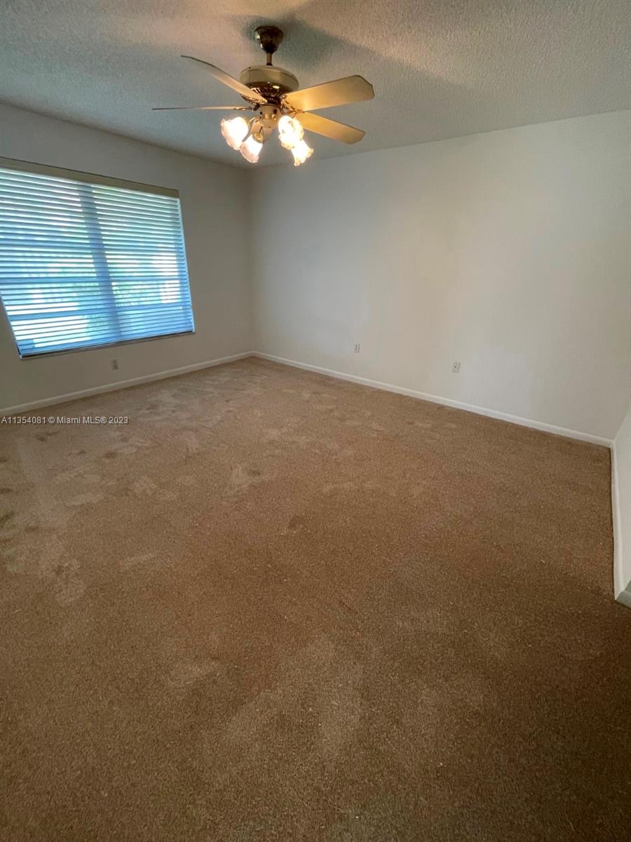 9054 Southwest 112th Place Miami, FL 33176 - Photo 13 of 21 an empty room with windows and fan