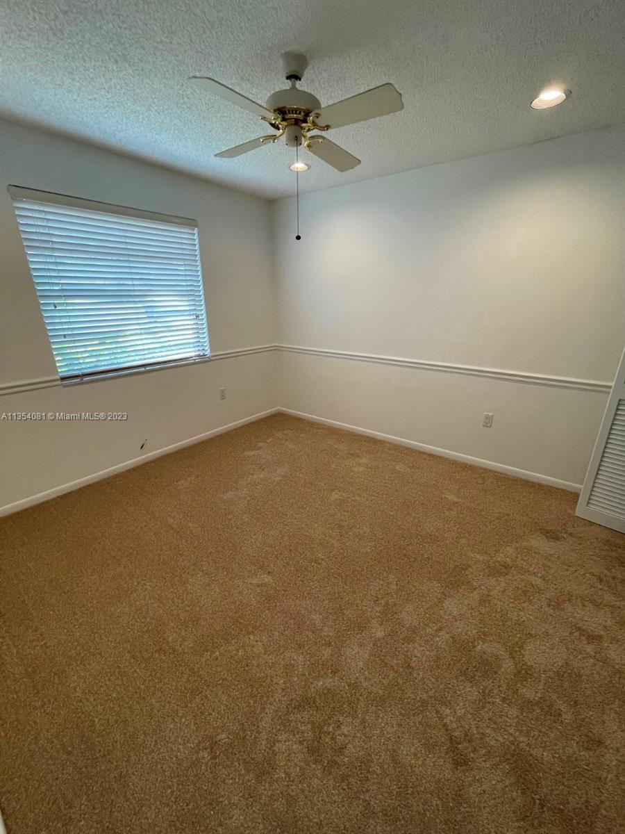 9054 Southwest 112th Place Miami, FL 33176 - Photo 19 of 21 an empty room with windows and fan
