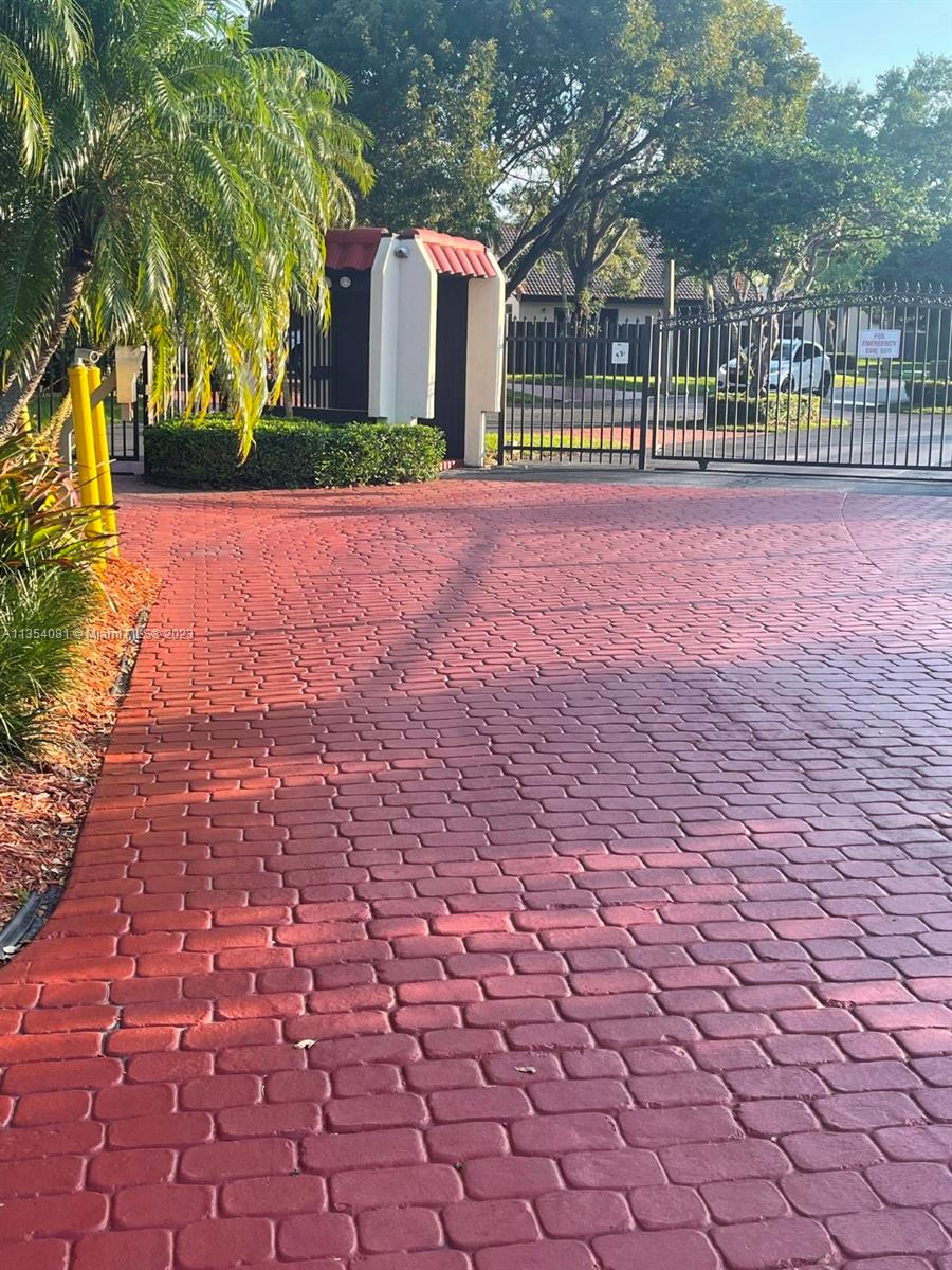 9054 Southwest 112th Place Miami, FL 33176 - Photo 5 of 21 a view of a brick building next to a yard