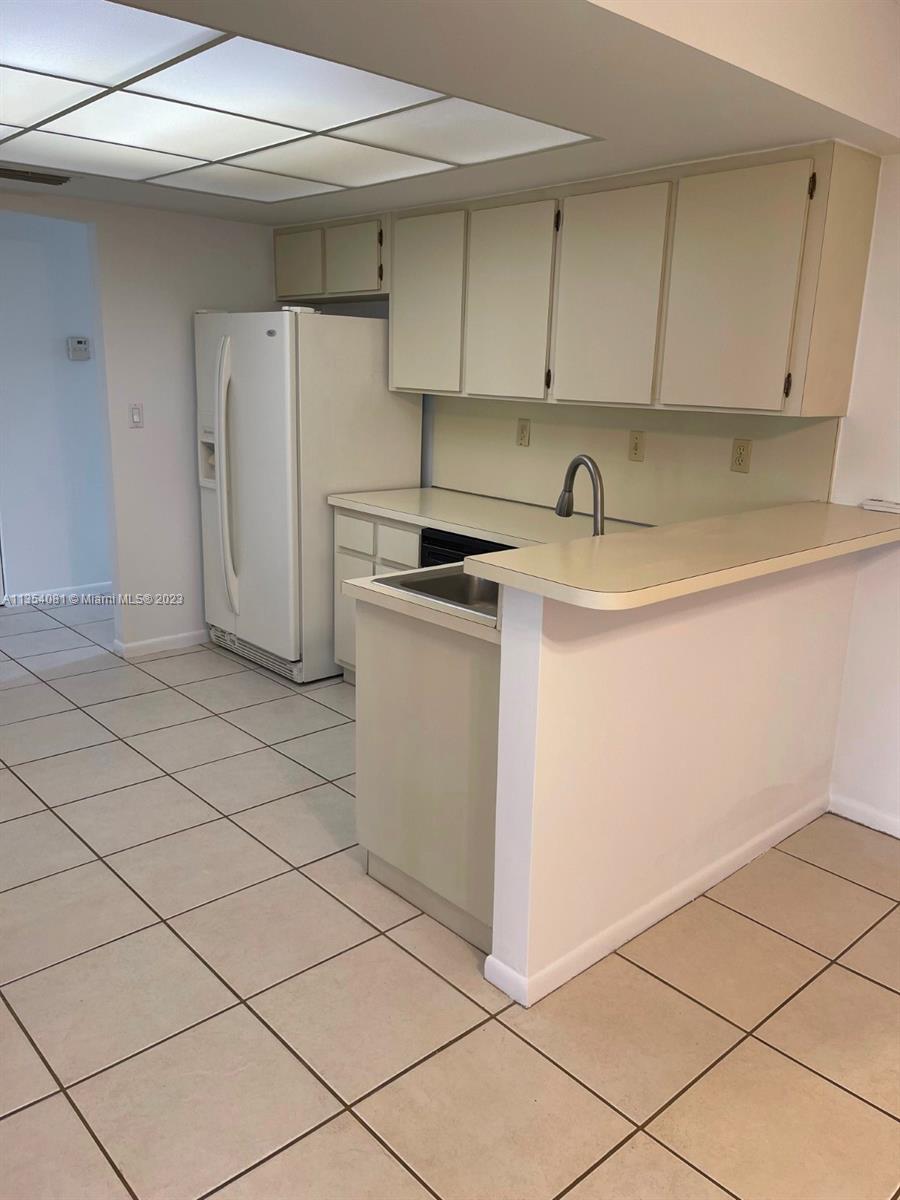 9054 Southwest 112th Place Miami, FL 33176 - Photo 8 of 21 a utility room with cabinets washer and dryer