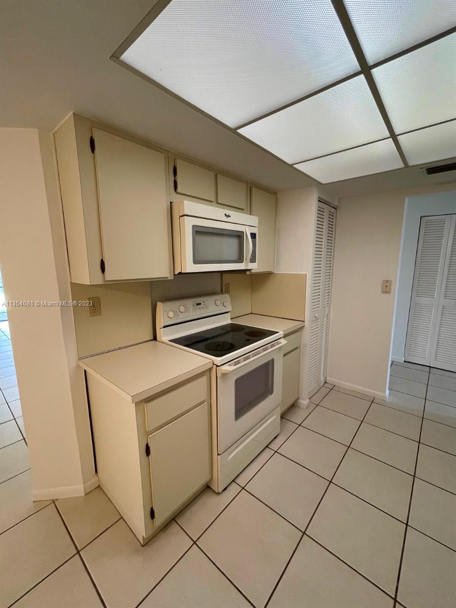 9054 Southwest 112th Place Miami, FL 33176 - Photo 9 of 21 a kitchen with a stove and a microwave