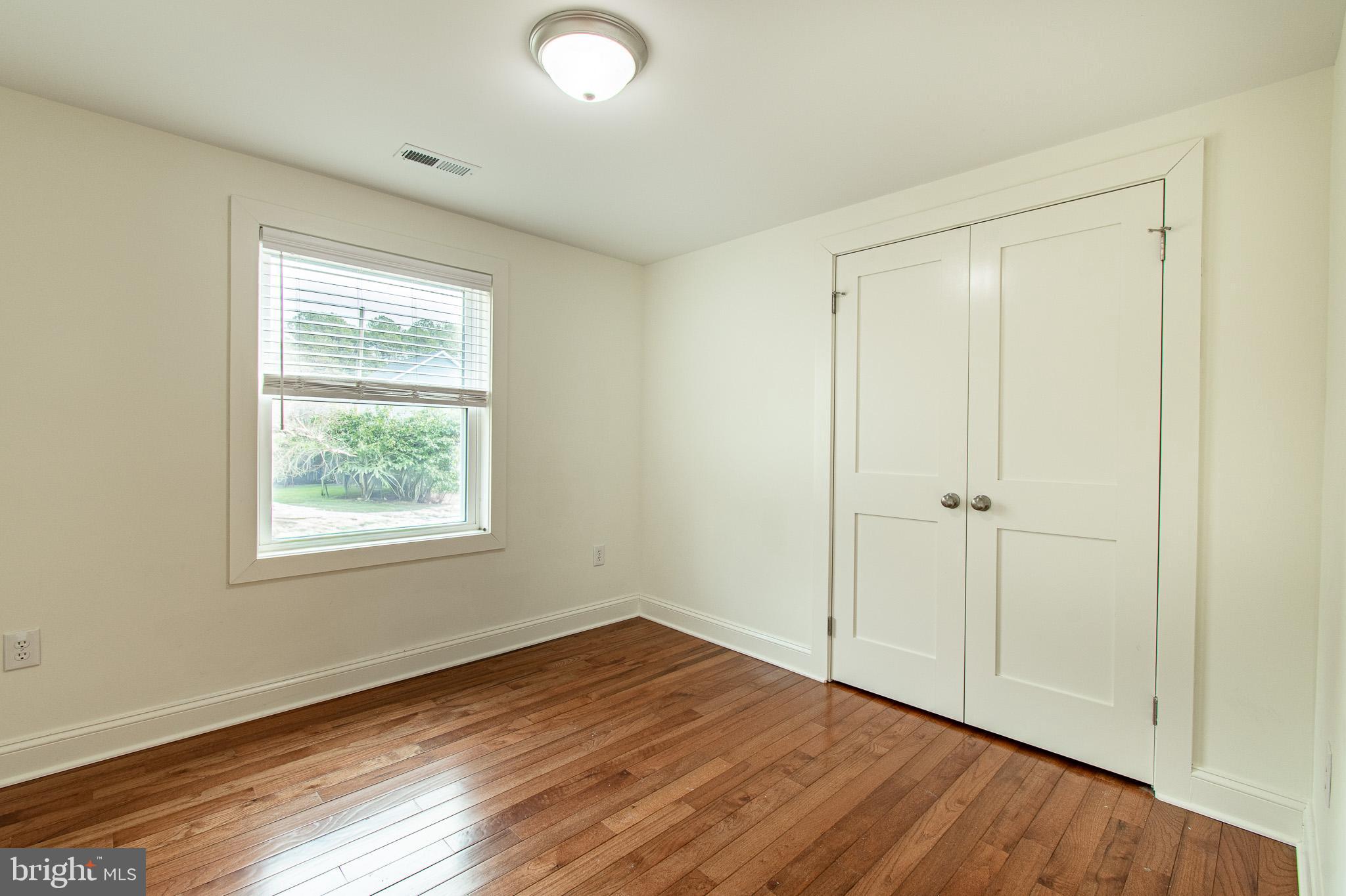 101 Brooks Lane St. Michaels, MD 21663 - Photo 12 of 19 a view of an empty room with wooden floor and a window