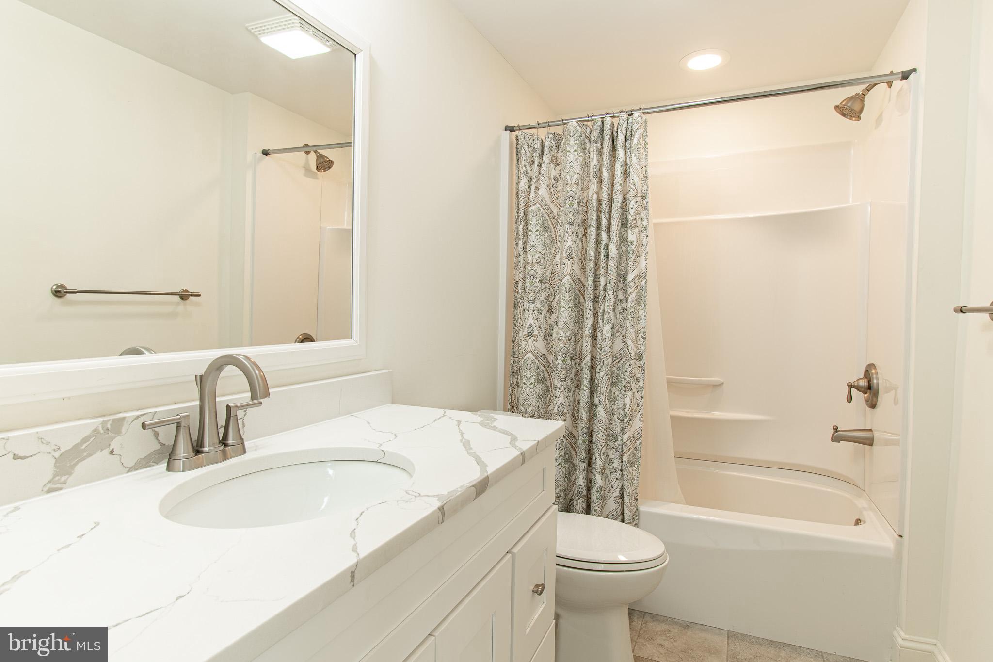101 Brooks Lane St. Michaels, MD 21663 - Photo 18 of 19 a bathroom with a sink toilet and shower