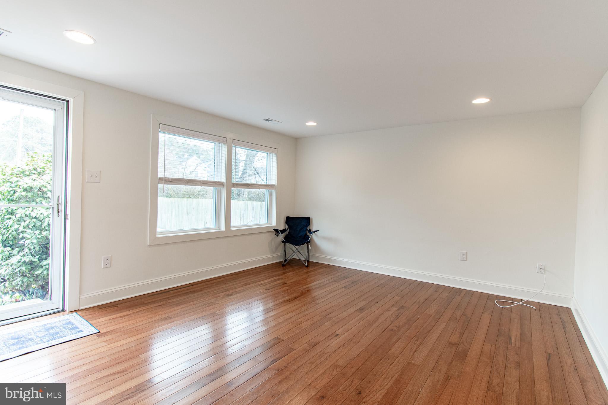 101 Brooks Lane St. Michaels, MD 21663 - Photo 5 of 19 an empty room with wooden floor and windows