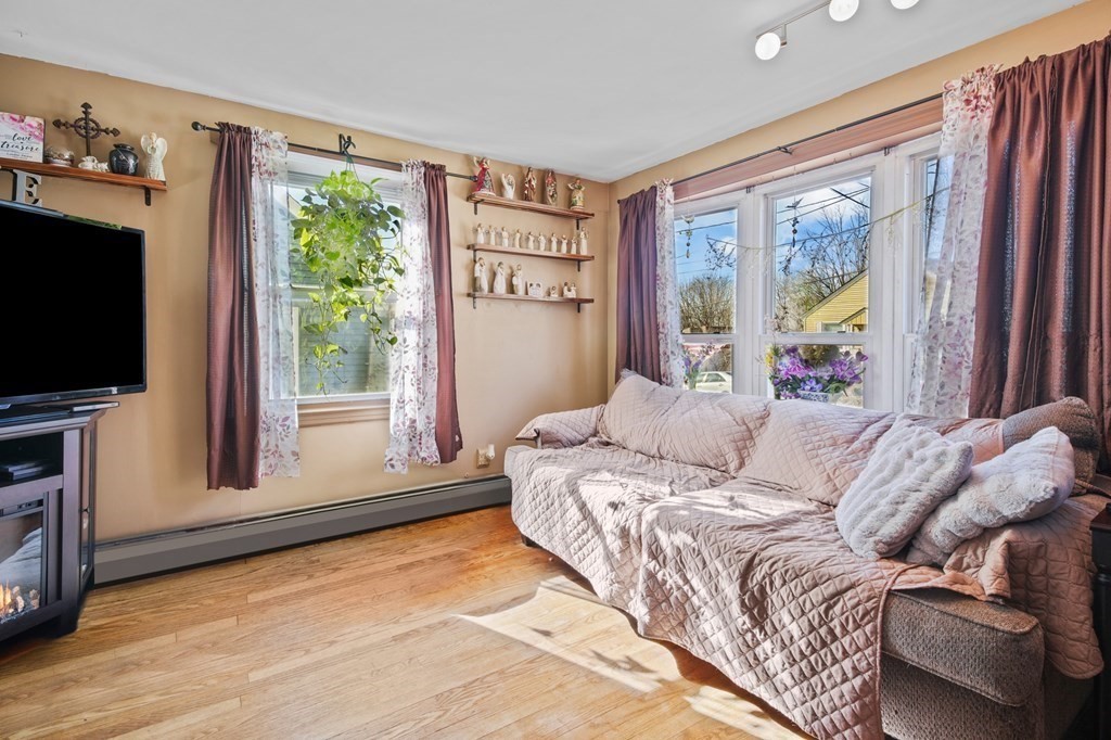 40 Harrison Street Cumberland, RI 02864 - Photo 7 of 37 a bed sitting in a bedroom next to a window