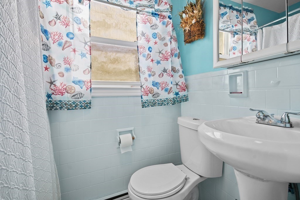 40 Harrison Street Cumberland, RI 02864 - Photo 10 of 37 a white toilet sitting next to a bathroom sink