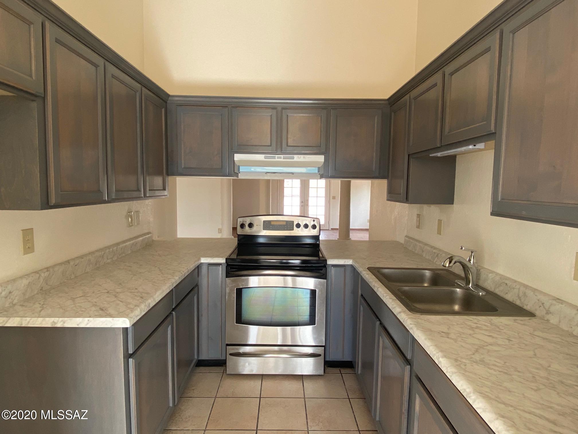230 Camino Turmalina Rio Rico, AZ 85648 - Photo 3 of 15 a kitchen with a stove sink and cabinets