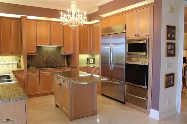 a kitchen with cabinets and stainless steel appliances