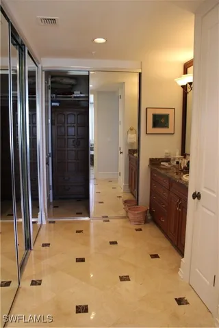 a bathroom with a tub sink and mirror