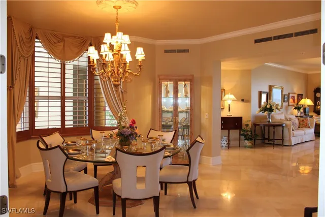 a view of a dining room with furniture and a chandelier