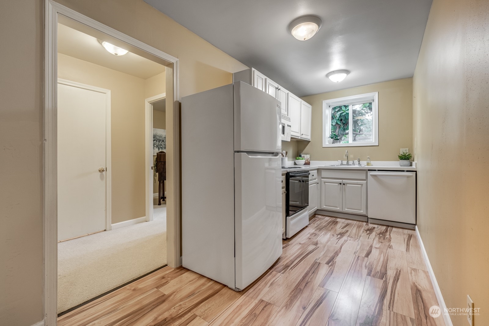 12325 Old Snohomish Monroe Road Snohomish, WA 98290 - Photo 26 of 40 a kitchen with white cabinets and white appliances