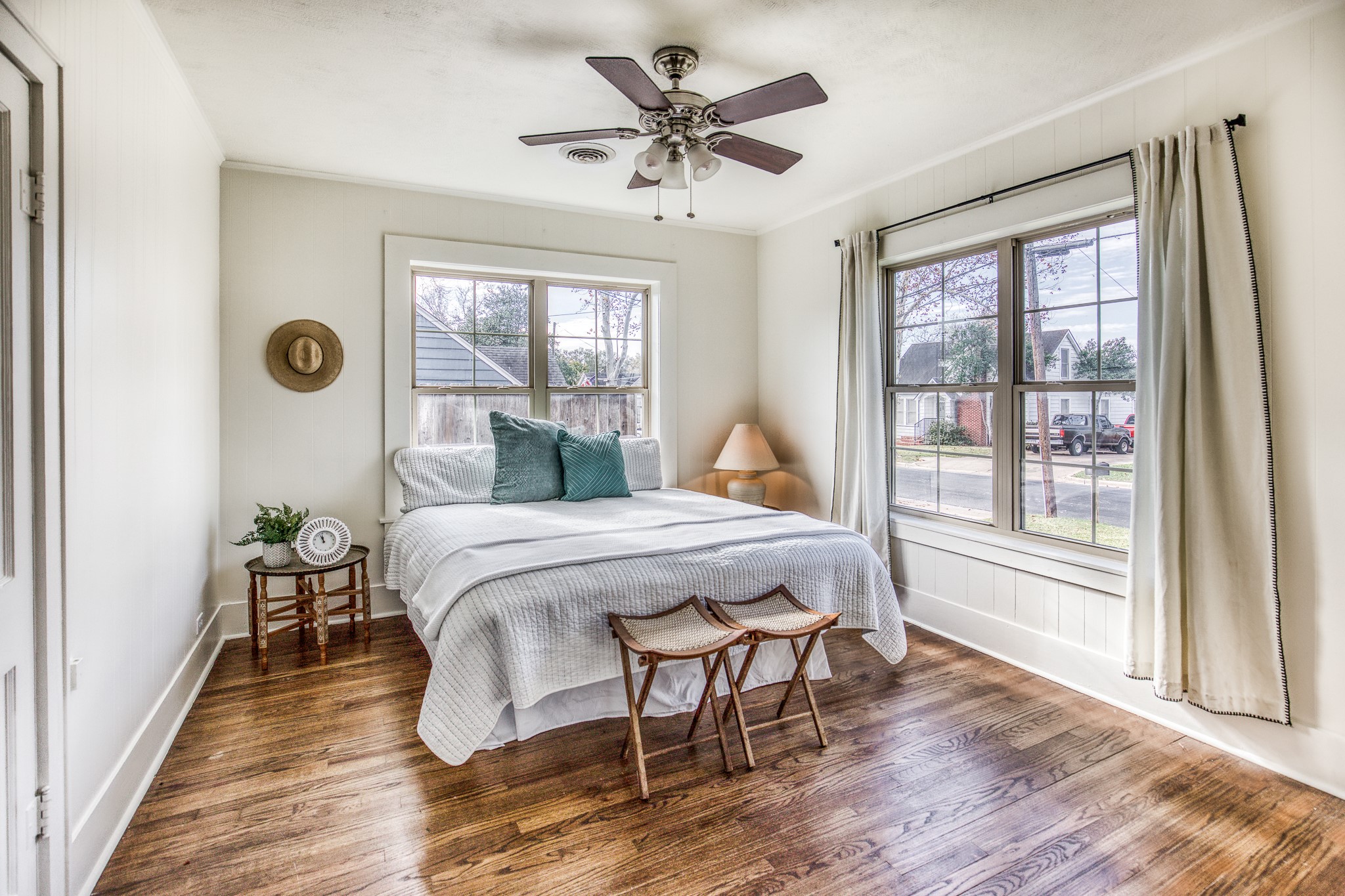 602 Alma Street Brenham, TX 77833 - Photo 14 of 20 a bedroom with a bed and a large window with wooden floor