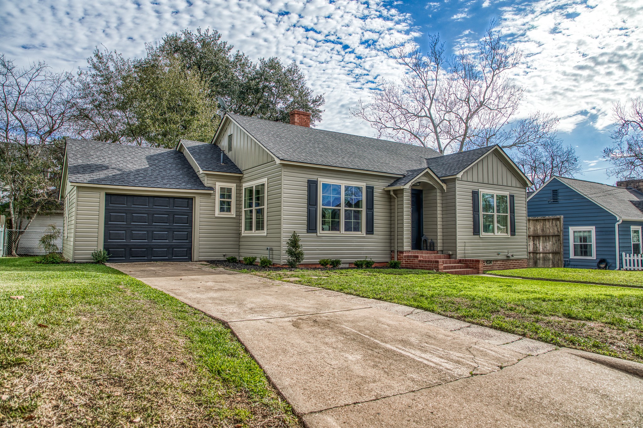 602 Alma Street Brenham, TX 77833 - Photo 2 of 20 a front view of a house with a garden and trees