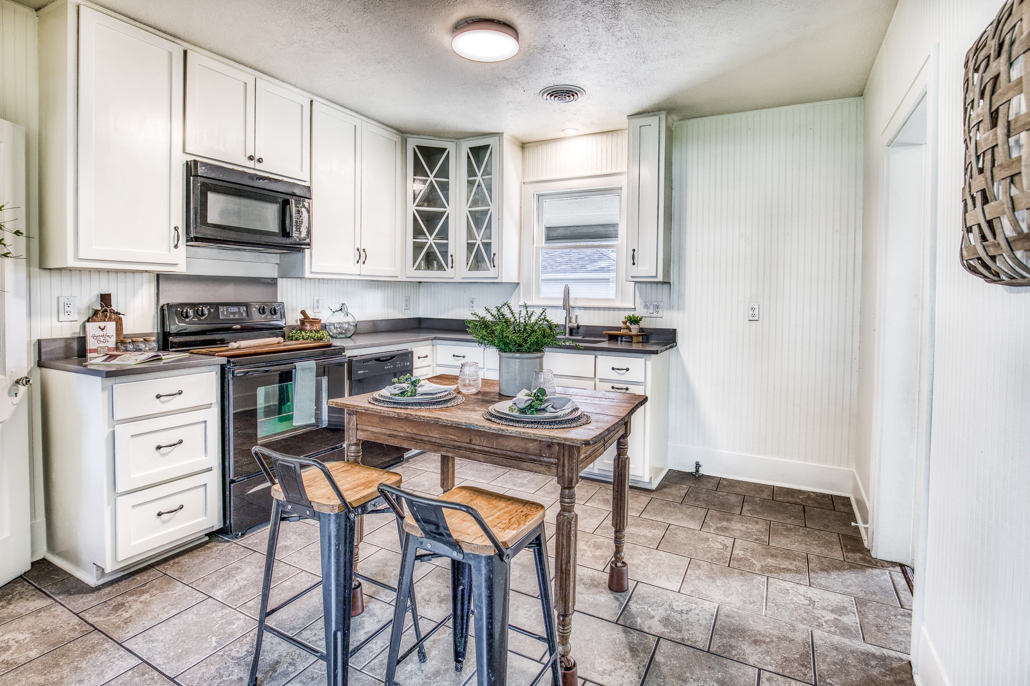 602 Alma Street Brenham, TX 77833 - Photo 7 of 20 a kitchen with stainless steel appliances kitchen island granite countertop a sink a stove a dining table and chairs