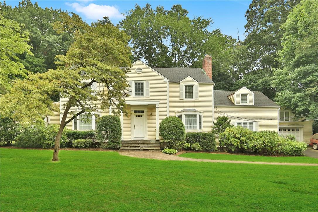27 Sunny Ridge Road Harrison, NY 10528 - Photo 1 of 1 a front view of a house with a garden