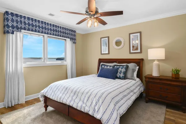 a bedroom with a large bed and a chandelier