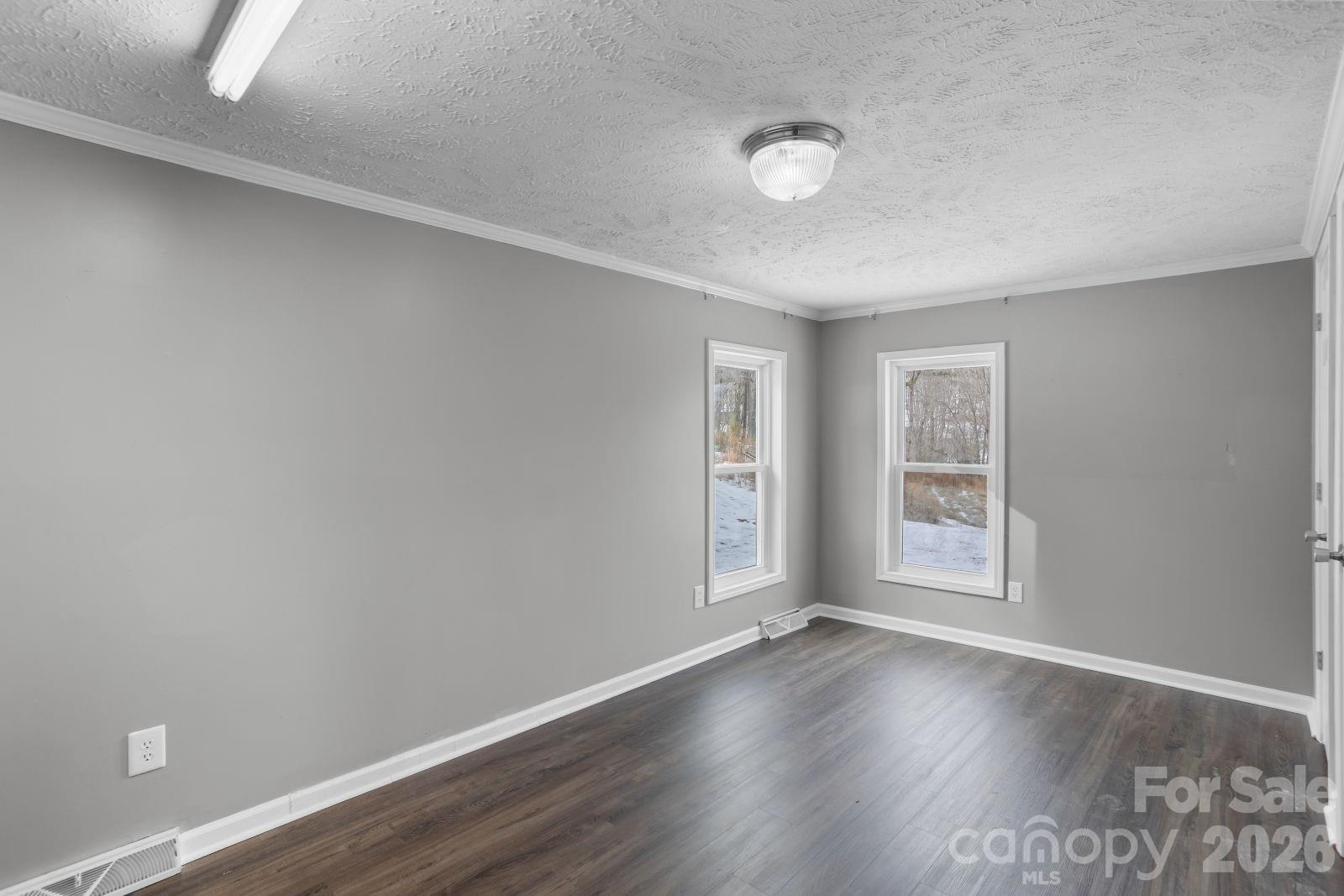 4855 Talley Road Walkertown, NC 27051 - Photo 32 of 45 an empty room with wooden floor and windows