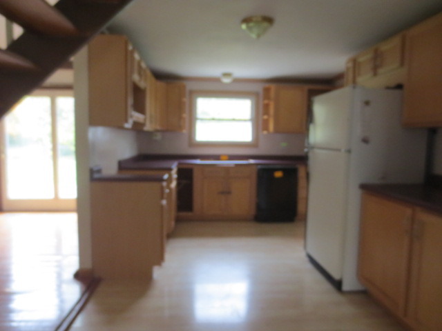 202 Seabury Road Bolingbrook, IL 60440 - Photo 4 of 14 a kitchen with stainless steel appliances granite countertop a refrigerator a sink a stove and a microwave