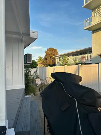 a view of balcony with wooden floor