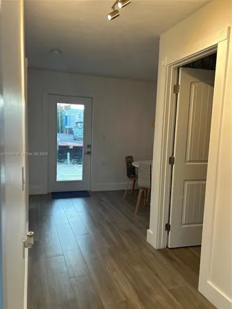 an empty room with wooden floor and a window