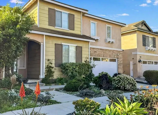 a front view of a house with a yard