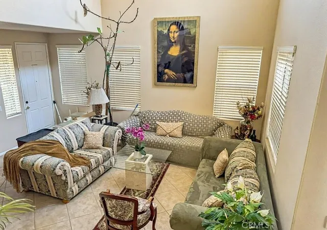a living room with furniture and a potted plant