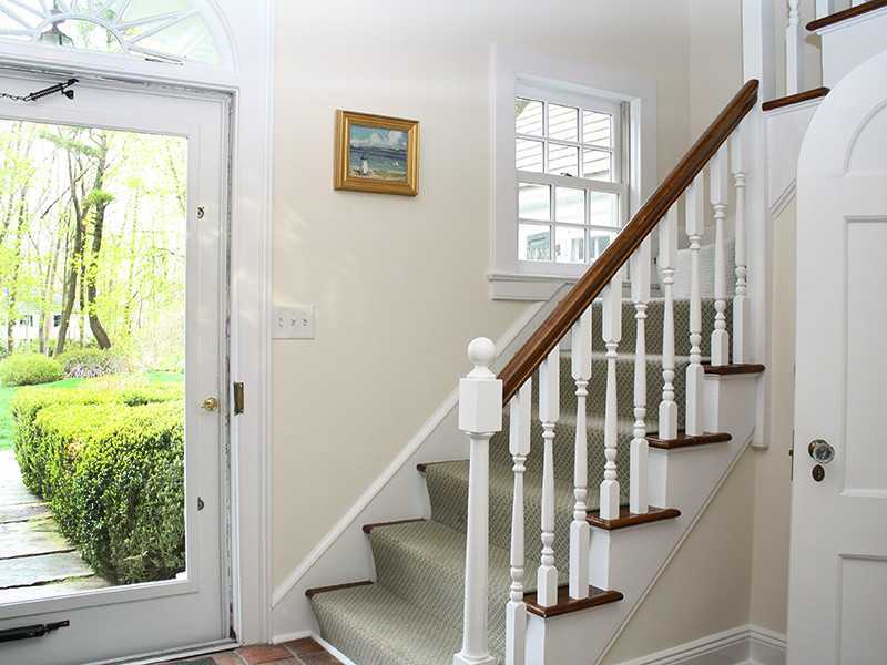 28 Leeward Lane Riverside, CT 06878 - Photo 4 of 23 a view of entryway with wooden floor and stairs