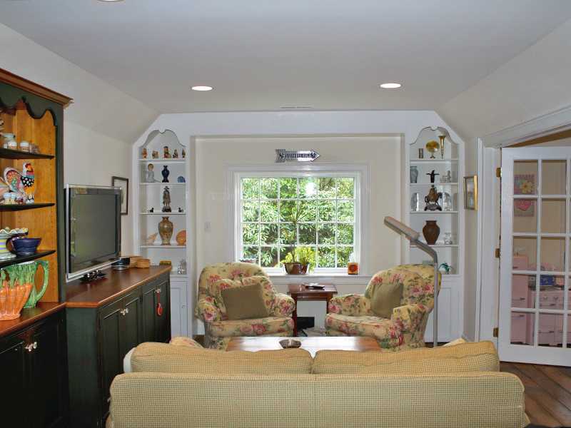 28 Leeward Lane Riverside, CT 06878 - Photo 7 of 23 a living room with furniture a flat screen tv and a floor to ceiling window