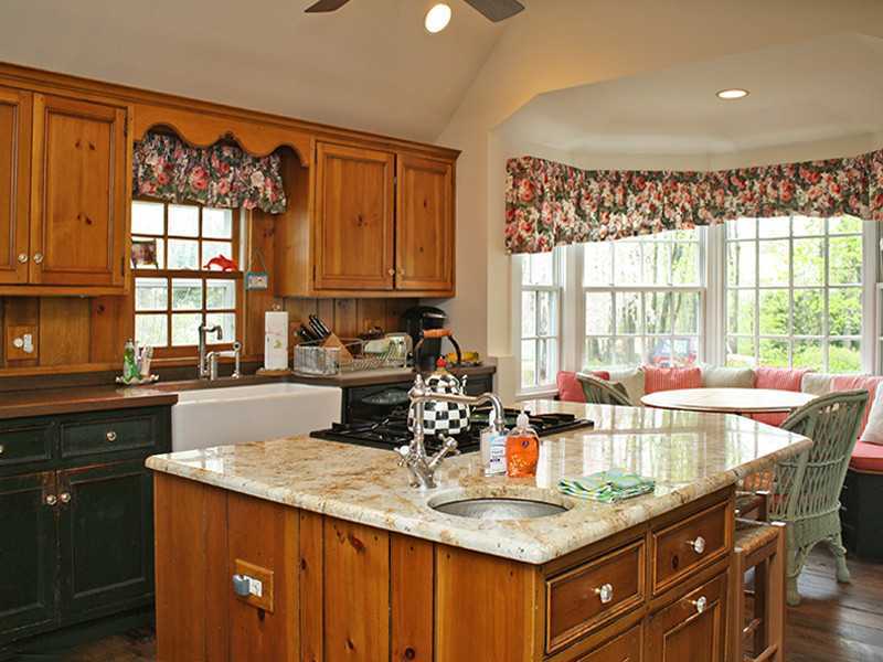28 Leeward Lane Riverside, CT 06878 - Photo 8 of 23 a kitchen with a granite countertop sink stove and cabinets