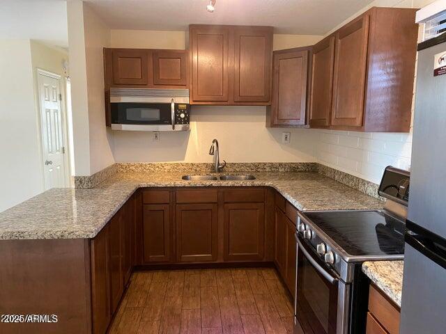 925 East Henry Street Tempe, AZ 85288 - Photo 11 of 21 a kitchen with stainless steel appliances granite countertop a sink stove and cabinets