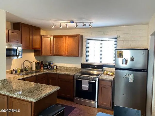 a kitchen with a sink stove top oven and cabinets