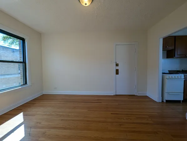 a view of wooden floor and windows in a room