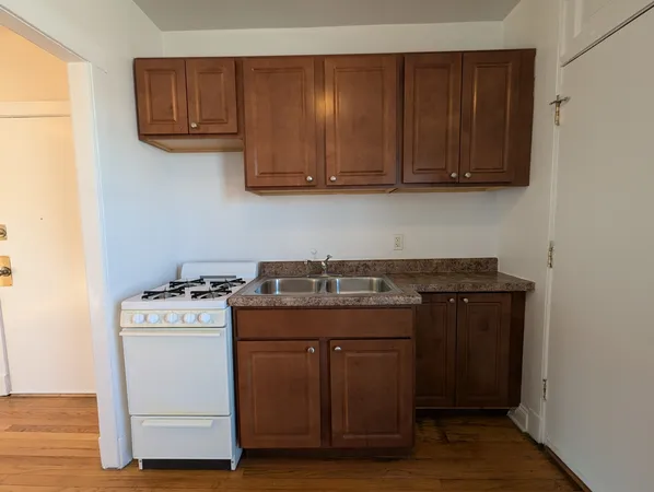a kitchen with stainless steel appliances granite countertop a stove and a microwave