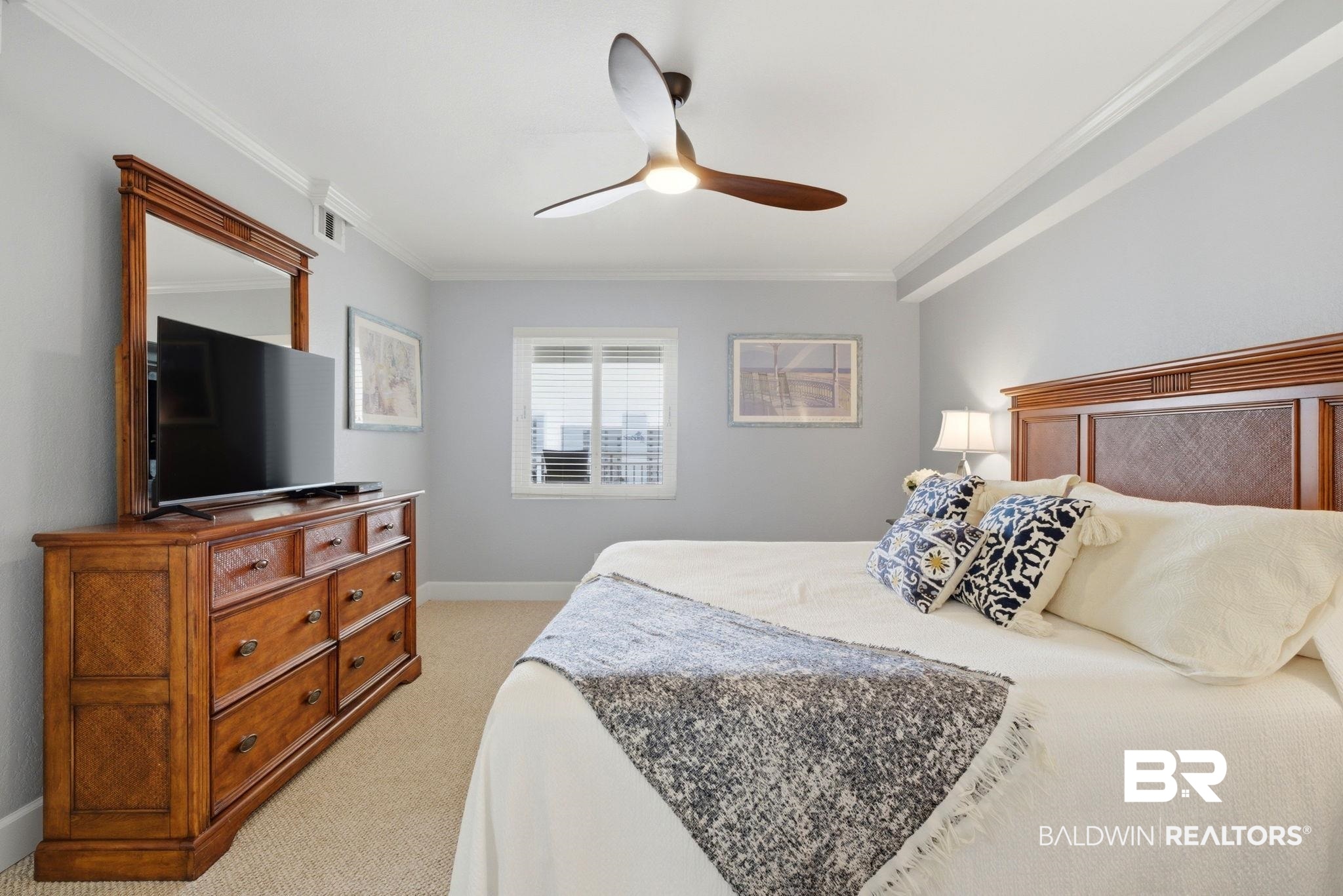 16284 Perdido Key Drive, Unit 912 Perdido Key, FL 32507 - Photo 31 of 49 Bedroom featuring light carpet, ceiling fan, and crown molding