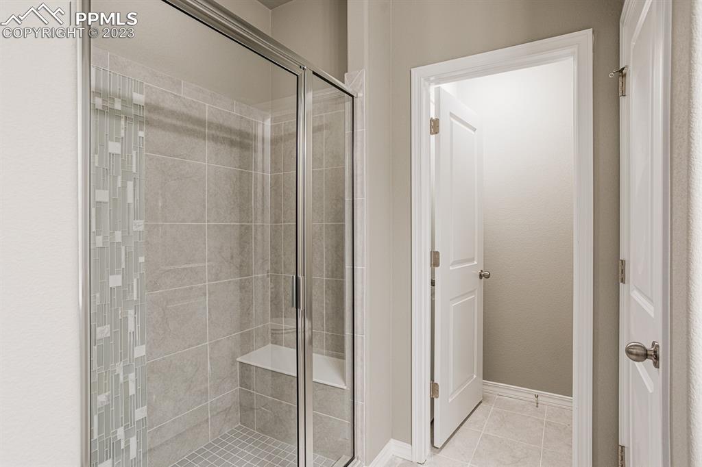 4336 Samaritan Loop Colorado Springs, CO 80916 - Photo 11 of 22 a bathroom with a glass shower door